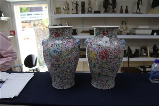 A pair of Chinese thousand flower baluster vases, Republic period, height 40cm excl. wood stands